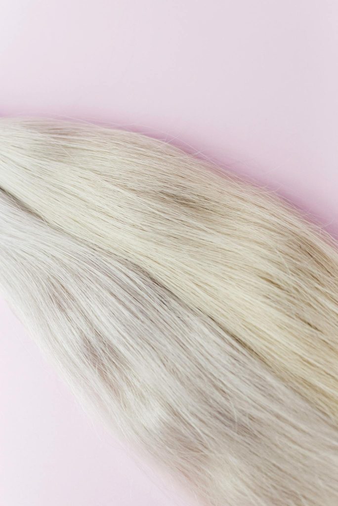 Shades of Natural Blond Hair on Light Pink Background